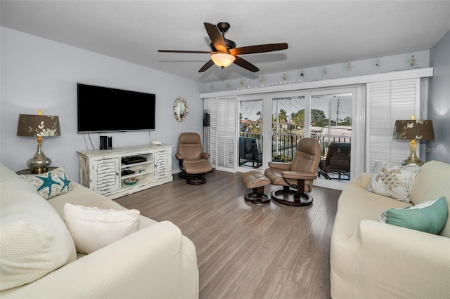 living room featuring hardwood / wood-style floors and ceiling fan