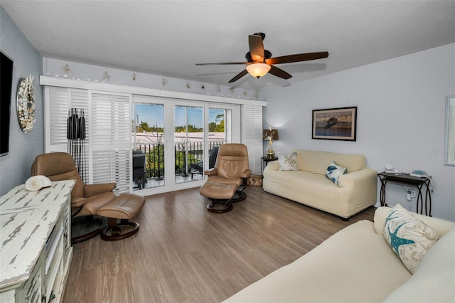 living room with hardwood / wood-style flooring and ceiling fan