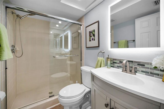 bathroom featuring walk in shower, vanity, toilet, and decorative backsplash