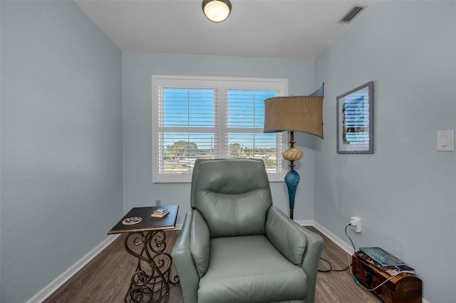 sitting room with wood-type flooring