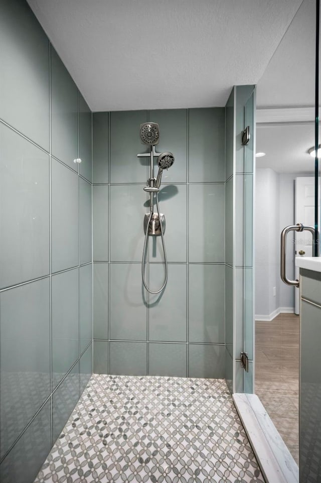 bathroom with vanity and a tile shower