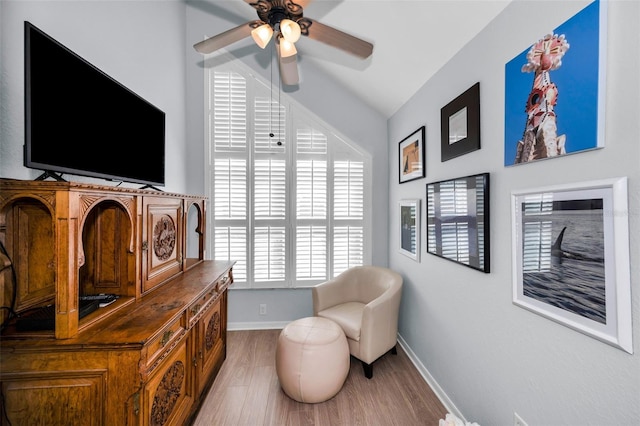 sitting room featuring ceiling fan, vaulted ceiling, and wood-type flooring