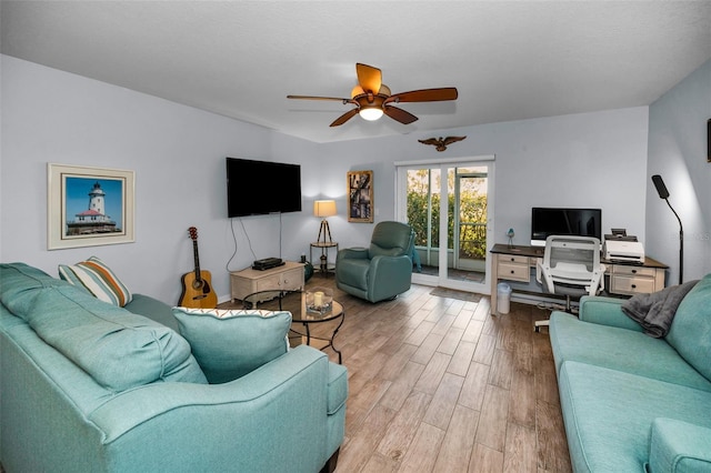 living room with ceiling fan and light wood-type flooring