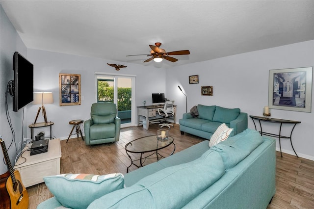 living room with wood-type flooring and ceiling fan