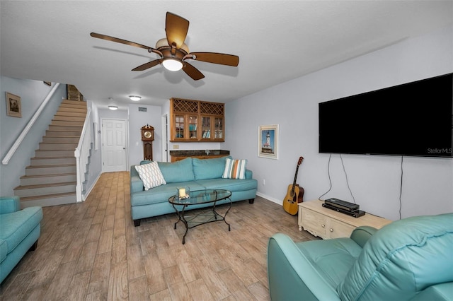 living room featuring ceiling fan and light hardwood / wood-style flooring