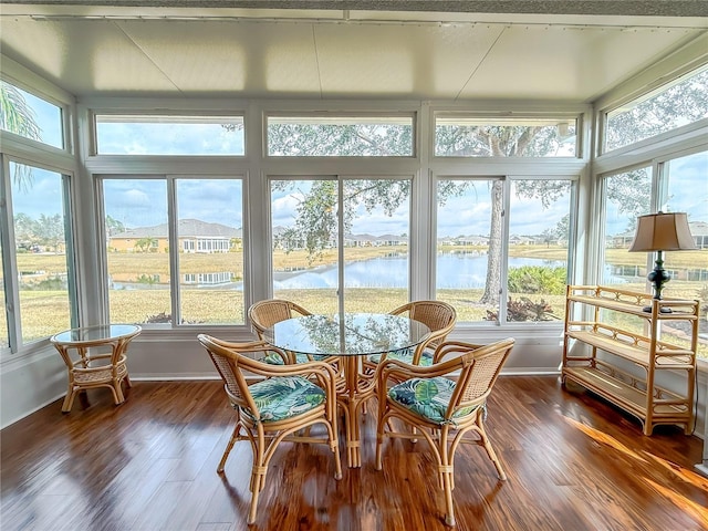 sunroom with a healthy amount of sunlight and a water view