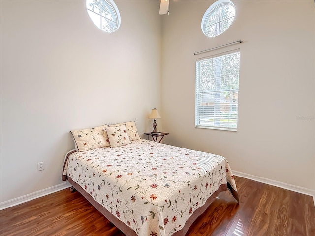 bedroom with dark wood-type flooring