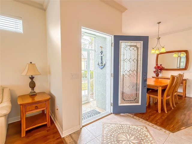 foyer featuring ornamental molding and tile patterned floors