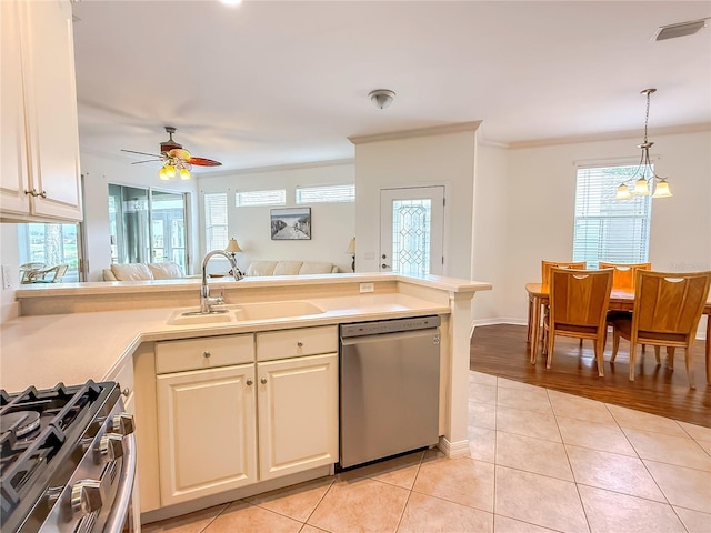 kitchen featuring sink, light tile patterned floors, hanging light fixtures, and appliances with stainless steel finishes