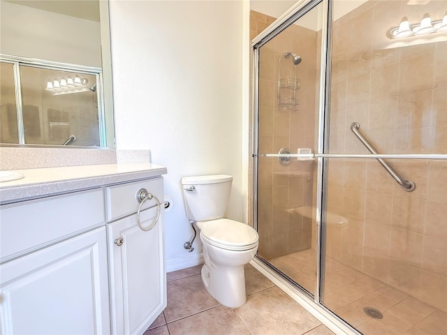 bathroom with walk in shower, vanity, toilet, and tile patterned flooring