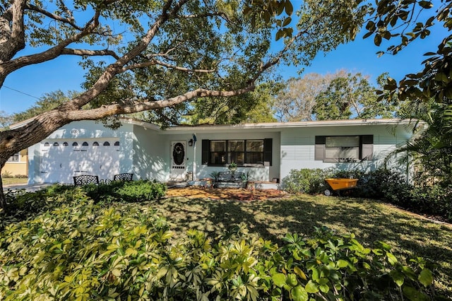 back of property featuring a yard and a garage