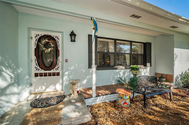 doorway to property featuring a porch