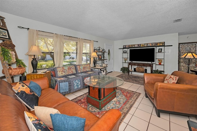 living room featuring light tile patterned flooring and a textured ceiling