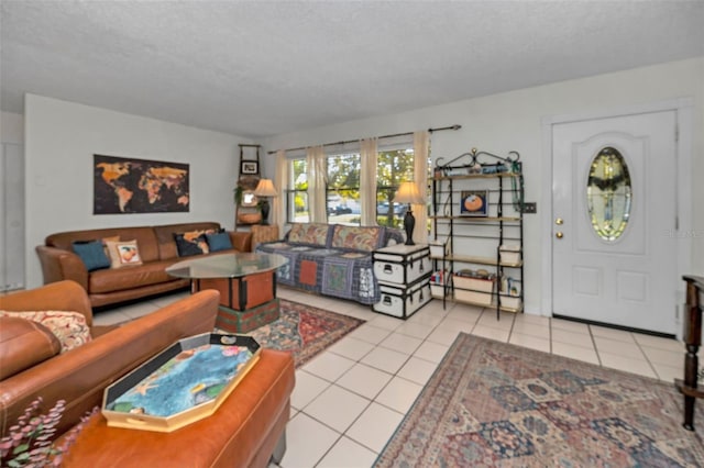 living room with light tile patterned flooring and a textured ceiling