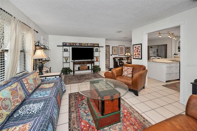 living room with light tile patterned floors and a textured ceiling