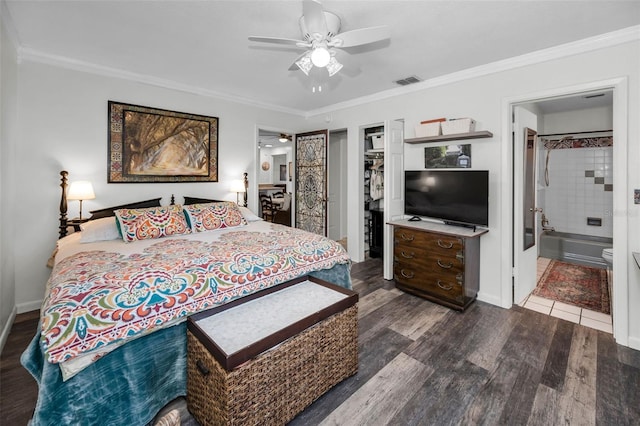 bedroom featuring a walk in closet, connected bathroom, and a closet