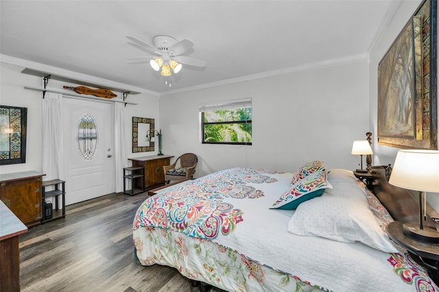 bedroom with dark hardwood / wood-style flooring, ornamental molding, and ceiling fan