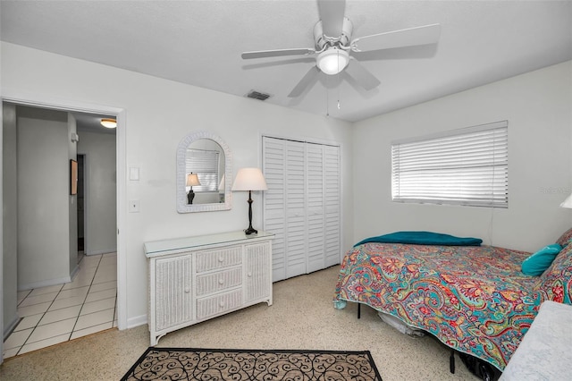 bedroom with ceiling fan and a closet