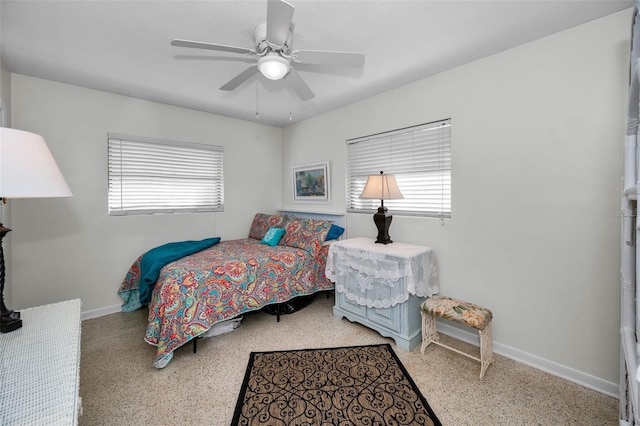 bedroom with multiple windows and ceiling fan