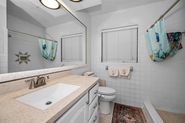 bathroom featuring vanity, toilet, curtained shower, and tile walls