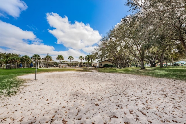 view of home's community with volleyball court and a lawn