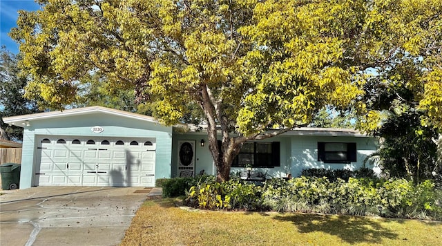 ranch-style home with a garage and a front yard