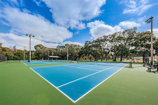 view of tennis court featuring fence