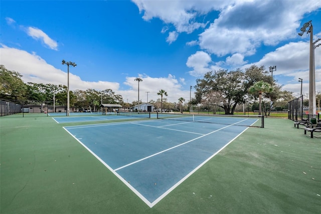 view of sport court featuring fence