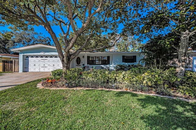 ranch-style home with a garage, driveway, a front lawn, and fence