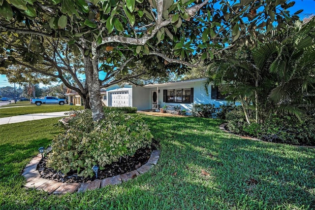 single story home featuring a front yard and an attached garage