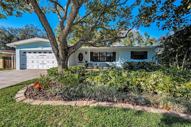 single story home with driveway and an attached garage