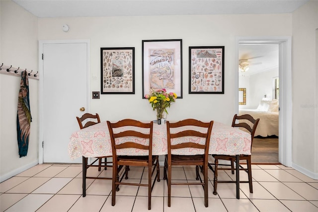 dining space with light tile patterned floors and baseboards