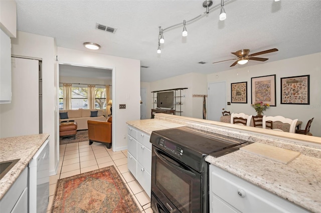 kitchen featuring a textured ceiling, dishwashing machine, light tile patterned flooring, visible vents, and black electric range