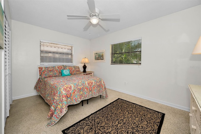 bedroom featuring ceiling fan, speckled floor, and baseboards