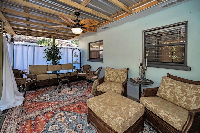 living room with beam ceiling, visible vents, plenty of natural light, and ceiling fan