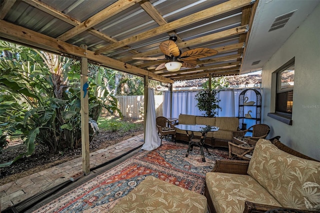 sunroom with ceiling fan and visible vents