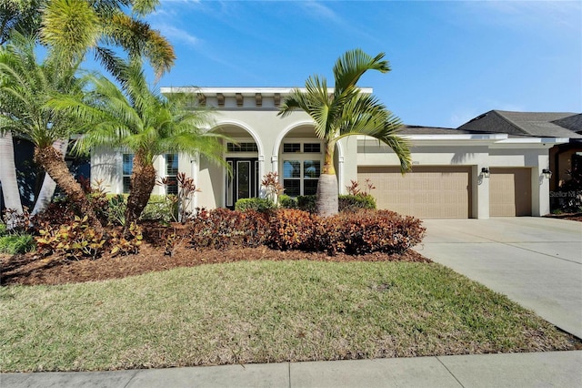 view of front of home with a garage and a front yard