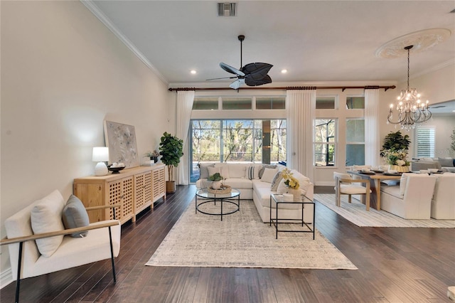 living room with crown molding, ceiling fan with notable chandelier, and dark hardwood / wood-style flooring