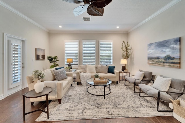 living room featuring hardwood / wood-style flooring, a healthy amount of sunlight, and ornamental molding