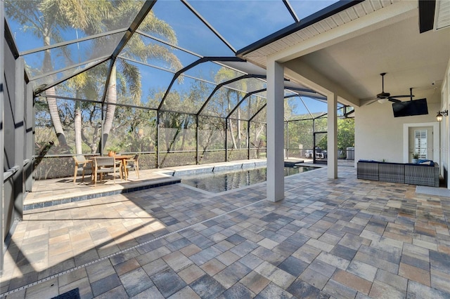 view of patio / terrace with an outdoor living space, ceiling fan, and glass enclosure