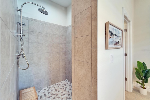 bathroom with a tile shower and tile patterned floors