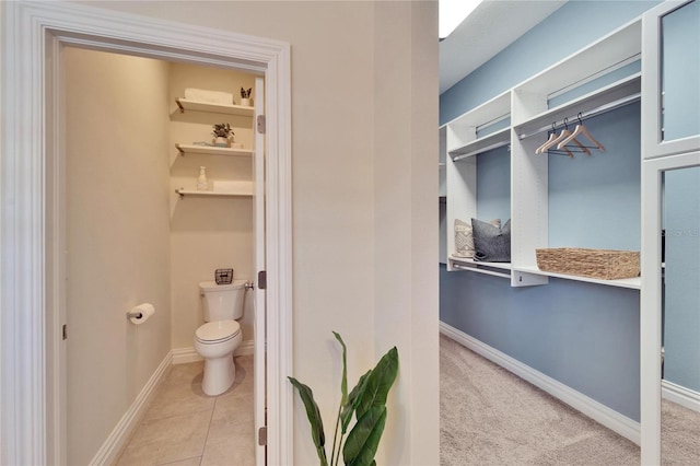 bathroom featuring toilet and tile patterned flooring