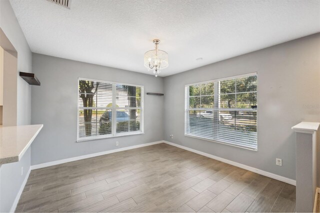 unfurnished dining area with a notable chandelier