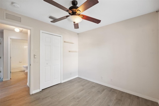 unfurnished bedroom with ceiling fan, light hardwood / wood-style floors, and a closet