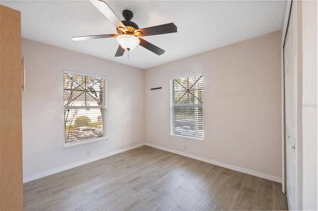 empty room featuring light hardwood / wood-style flooring and ceiling fan