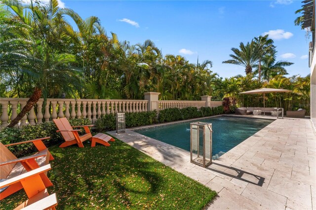 view of swimming pool featuring a fenced in pool, a patio, and fence