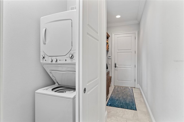 laundry room featuring laundry area, baseboards, stacked washer and clothes dryer, ornamental molding, and recessed lighting