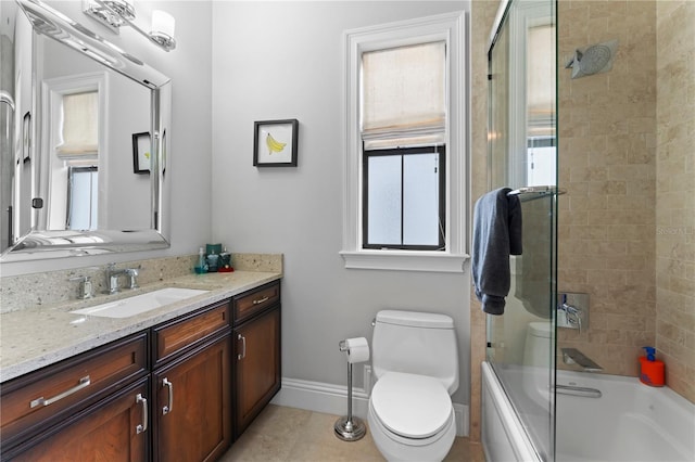 bathroom with tile patterned flooring, toilet, shower / bath combination with glass door, vanity, and baseboards