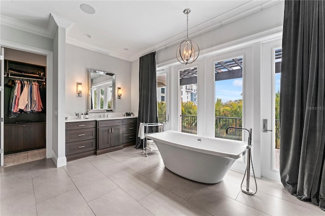 bathroom featuring crown molding, double vanity, a sink, tile patterned flooring, and a freestanding tub