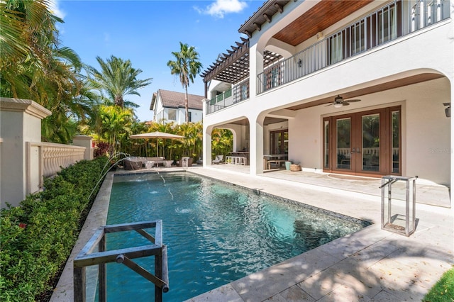 view of swimming pool featuring a fenced in pool, french doors, a ceiling fan, a patio area, and fence